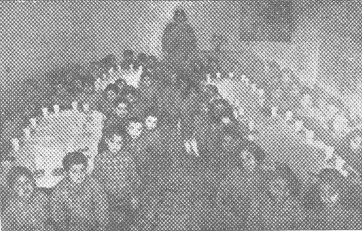 Children being served milk and cakes